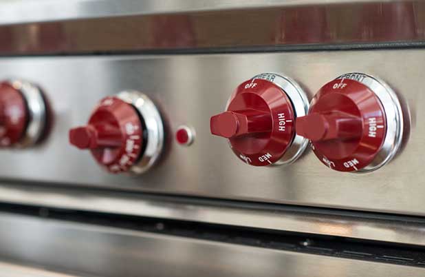 Red knobs on an oven.