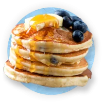 Close up of a stack of pancakes on blue background.