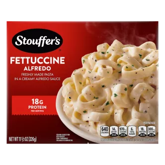 Box of Fettuccine Alfredo with a plate of pasta in cheese sauce below the product name and STOUFFER'S logo.