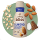Avena, almendras y trozos de coco flotan alrededor de un frasco de creamer natural bliss a base de plantas.